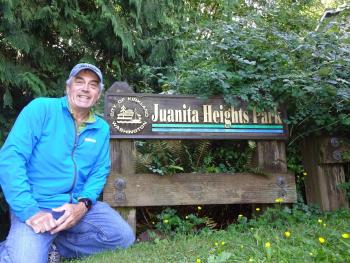 Man in front of Juanita Heights Park sign