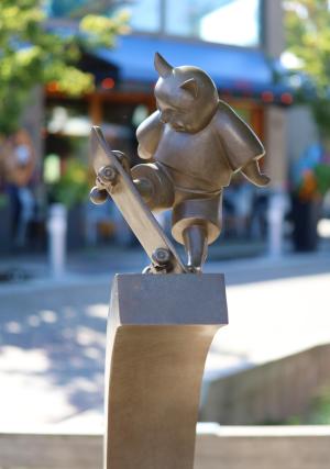 Sculpture of a cat skateboarding